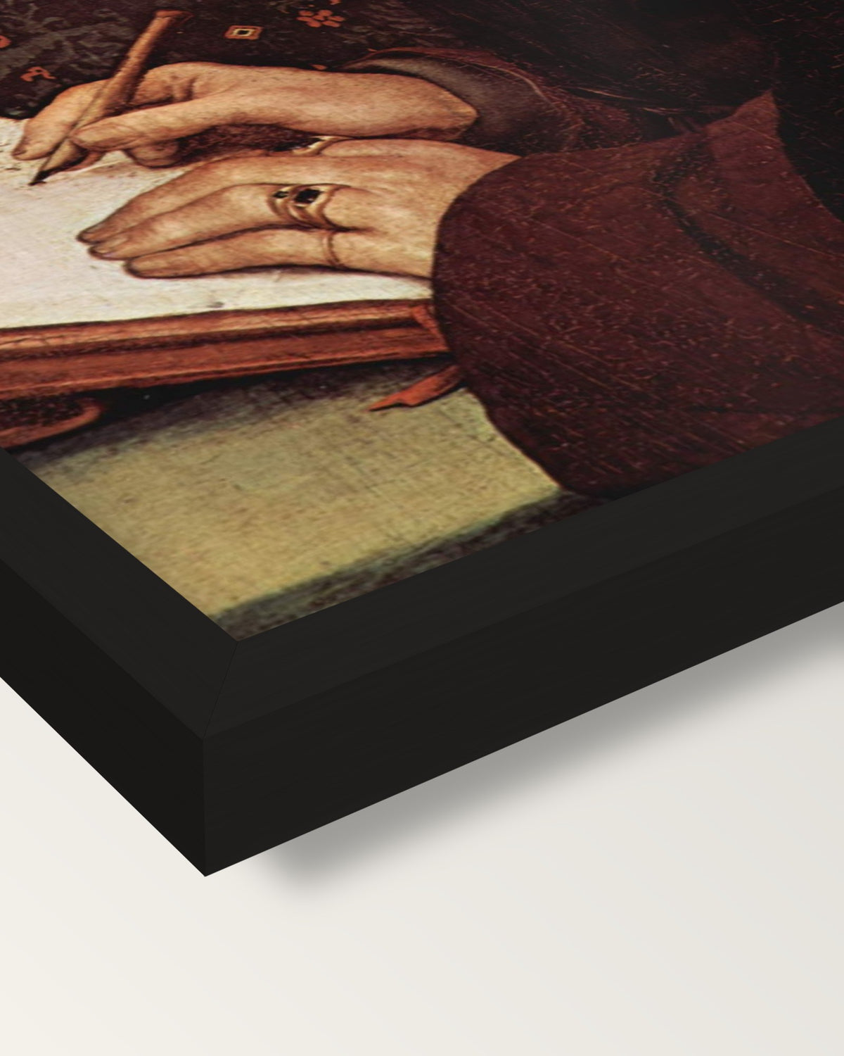 Erasmus Writing by the Younger framed print, corner close-up: black moulding, mitred, the print set just below its edge