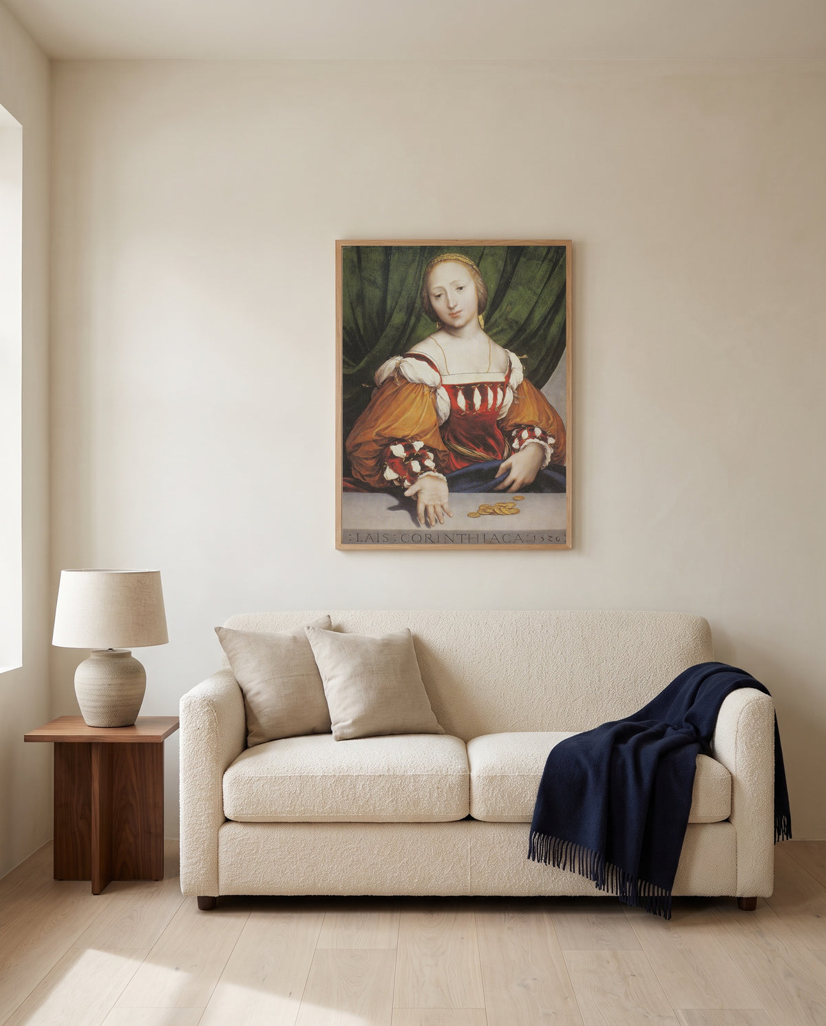 Lais of Corinth by Hans Holbein the Younger framed in natural oak above a cream sofa in a warm living room