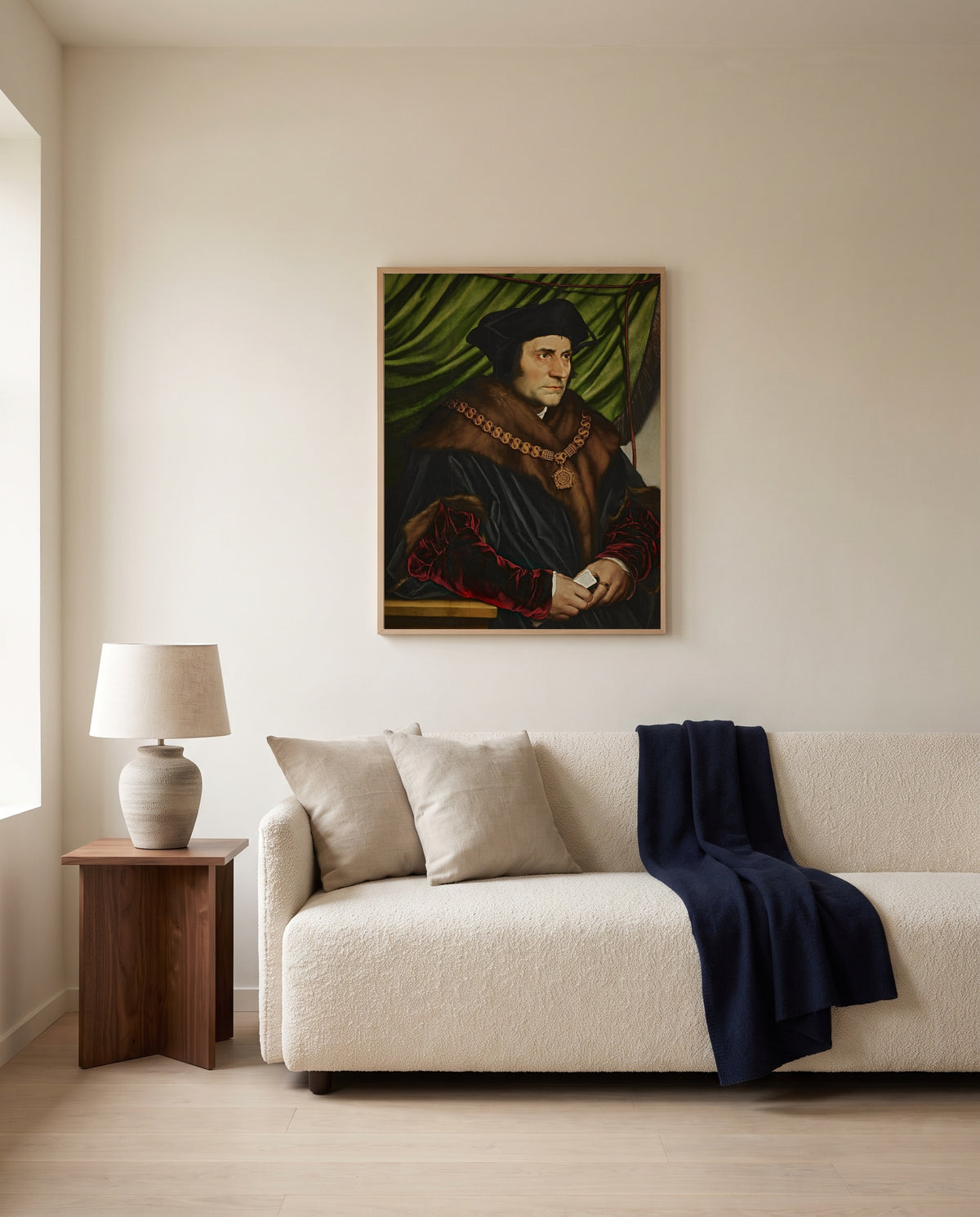 Sir Thomas More by Hans Holbein the Younger framed in natural oak above a cream sofa in a warm living room