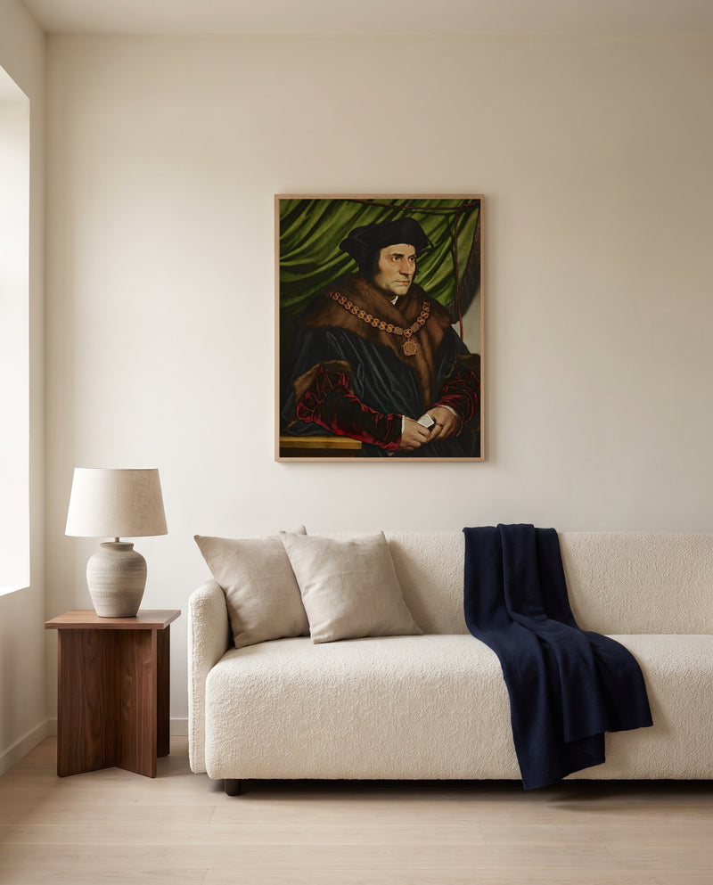 Sir Thomas More by Hans Holbein the Younger framed in natural oak above a cream sofa in a warm living room