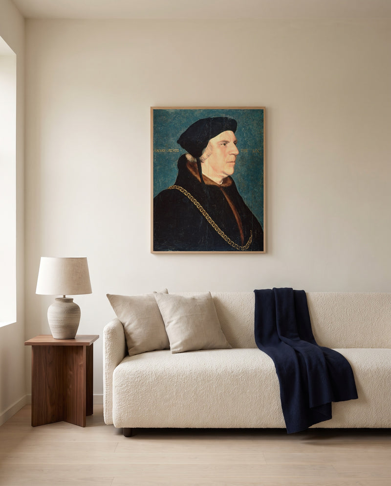 Sir William Butts by Hans Holbein the Younger framed in natural oak above a cream sofa in a warm living room