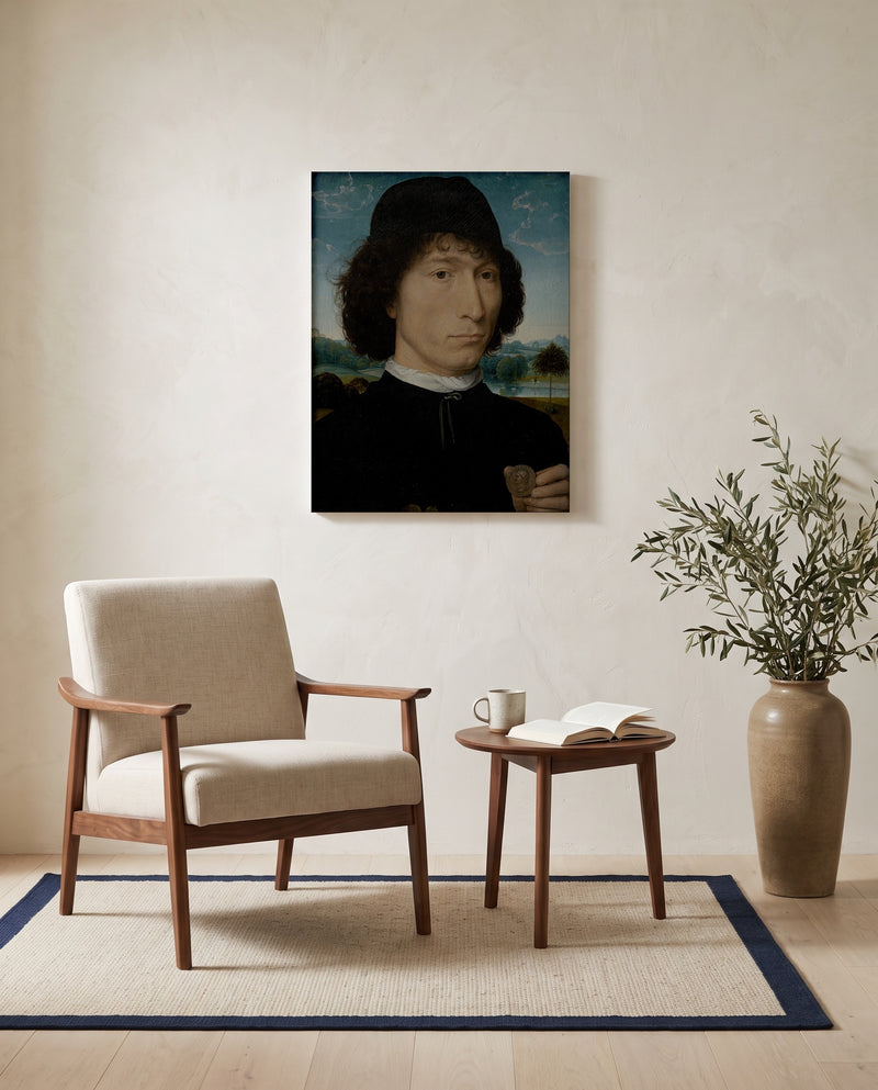 Man with a Roman Coin by Hans Memling as a stretched canvas above a linen lounge chair in a reading corner