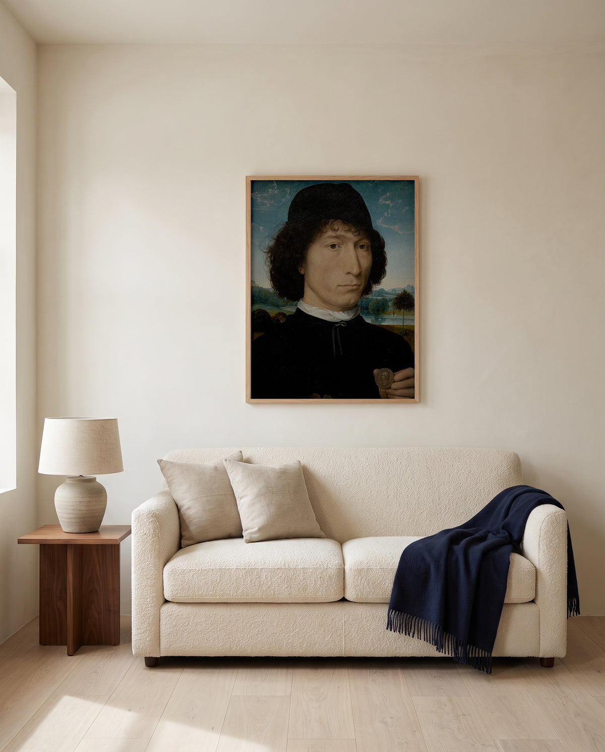 Man with a Roman Coin by Hans Memling framed in natural oak above a cream sofa in a warm living room