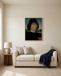 Man with a Roman Coin by Hans Memling framed in natural oak above a cream sofa in a warm living room