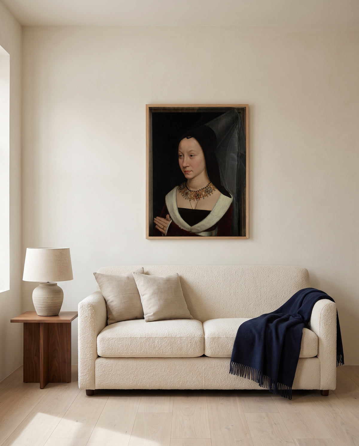Maria Portinari by Hans Memling framed in natural oak above a cream sofa in a warm living room