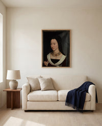 Maria Portinari by Hans Memling framed in natural oak above a cream sofa in a warm living room