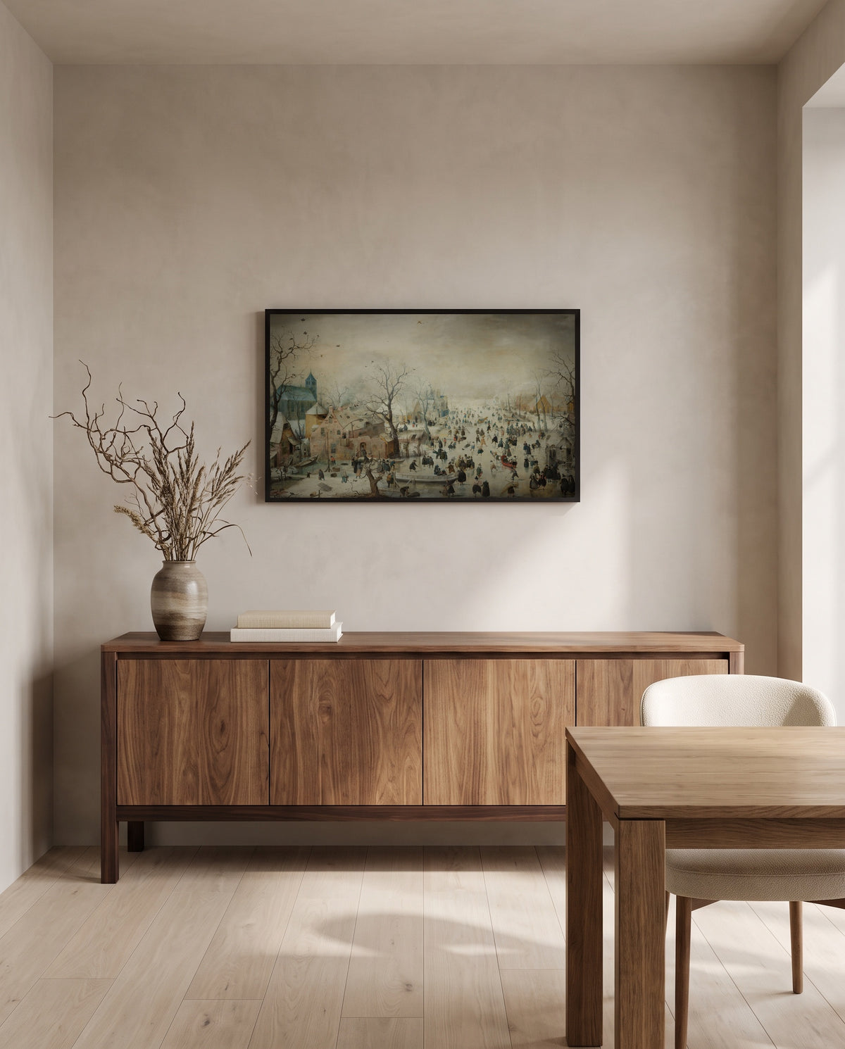 Winter Landscape, Skaters by Hendrick Avercamp in a black frame above a walnut sideboard in a dining room