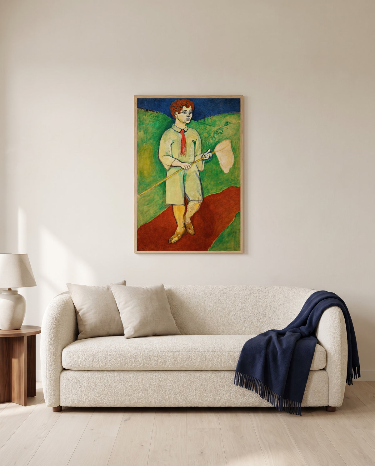 Boy with Butterfly Net by Henri Matisse framed in natural oak above a cream sofa in a warm living room