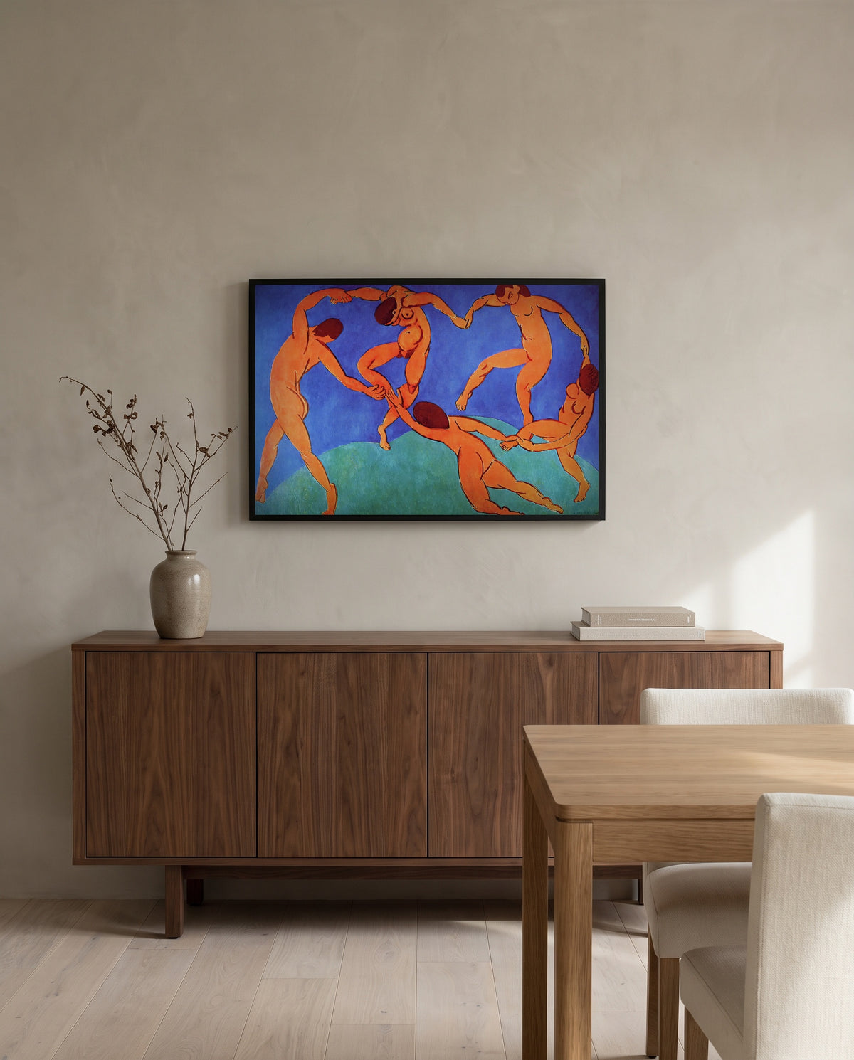 Dance (II) by Henri Matisse in a black frame above a walnut sideboard in a dining room