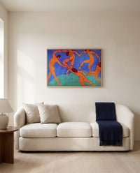 Dance (II) by Henri Matisse framed in natural oak above a cream sofa in a warm living room