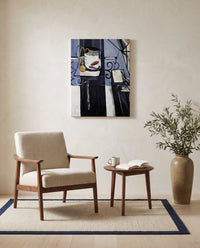 Goldfish and Palette by Henri Matisse as a stretched canvas above a linen lounge chair in a reading corner