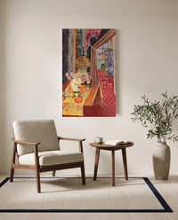 Flowers and Parakeets by Henri Matisse as a stretched canvas above a linen lounge chair in a reading corner
