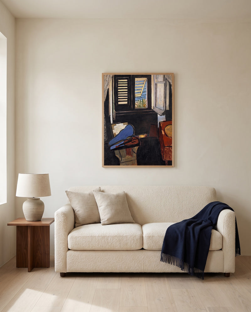 Interior with a Violin by Henri Matisse framed in natural oak above a cream sofa in a warm living room