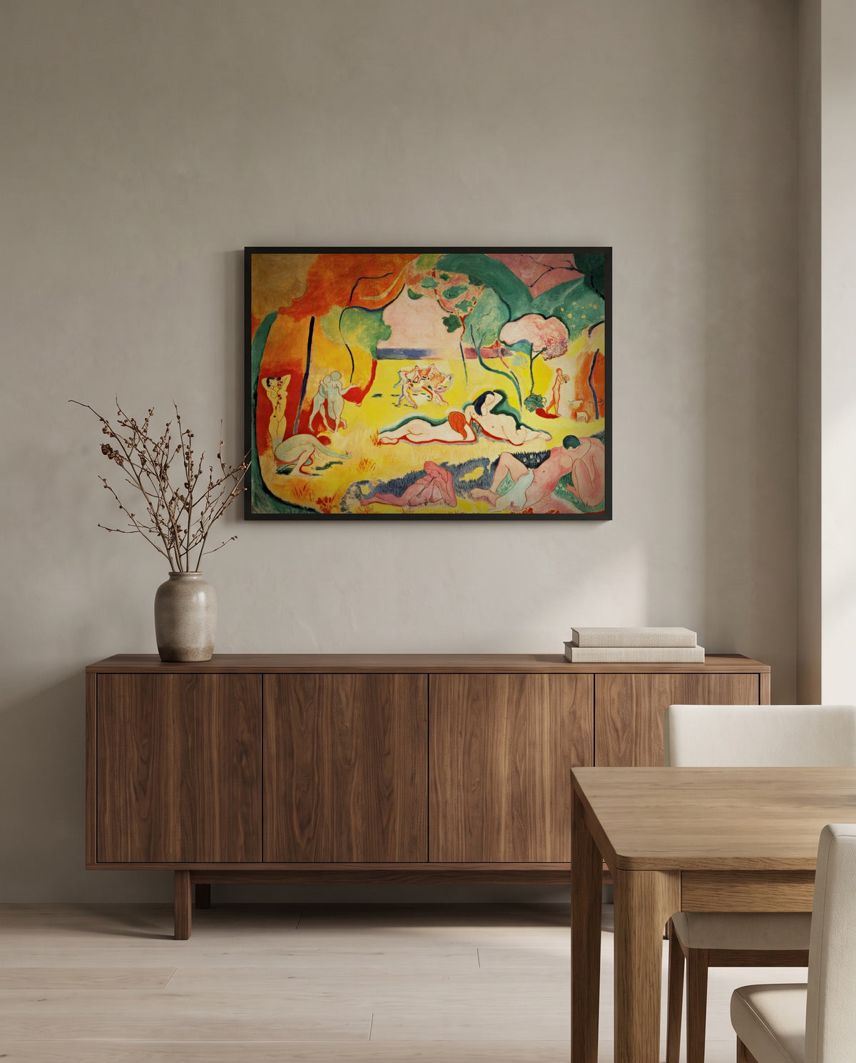 The Joy of Life by Henri Matisse in a black frame above a walnut sideboard in a dining room