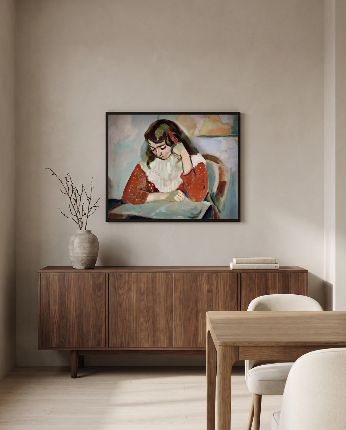 Marguerite Reading by Henri Matisse in a black frame above a walnut sideboard in a dining room