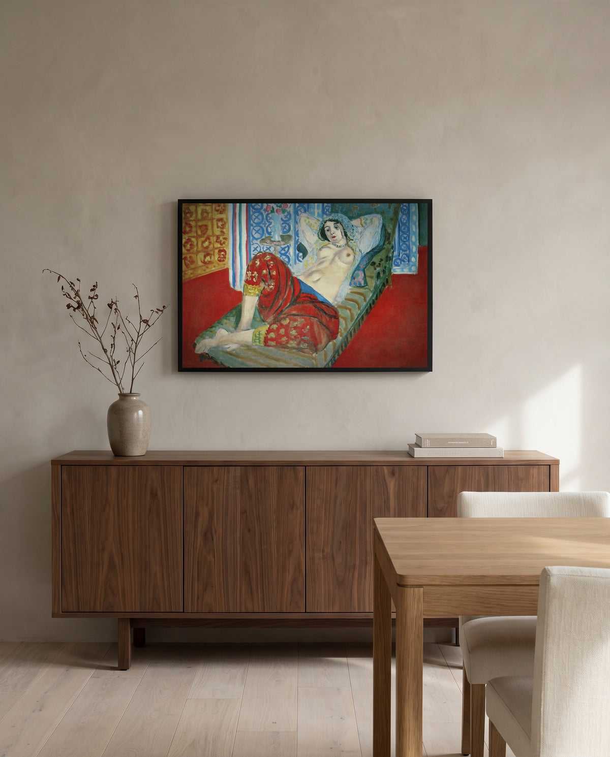 Odalisque, Red Culottes by Henri Matisse in a black frame above a walnut sideboard in a dining room