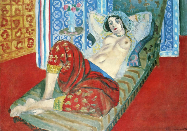Odalisque with Red Culottes by Matisse: a reclining woman in red trousers, bare to the waist, among patterned red cloths