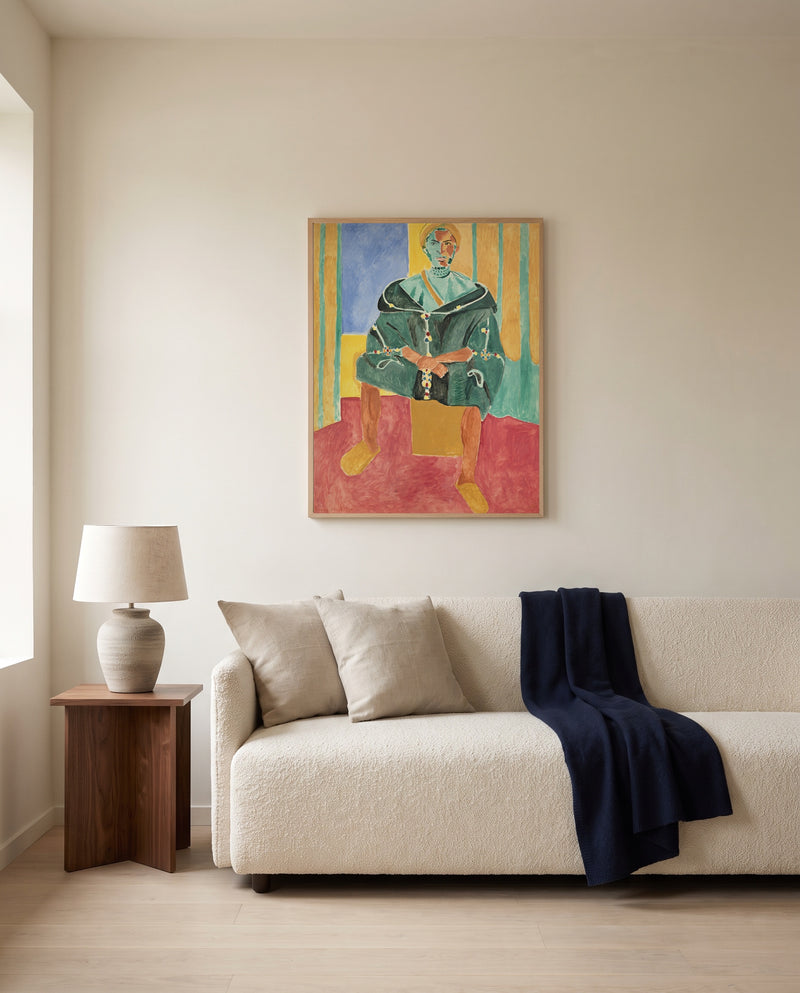 Seated Riffian by Henri Matisse framed in natural oak above a cream sofa in a warm living room
