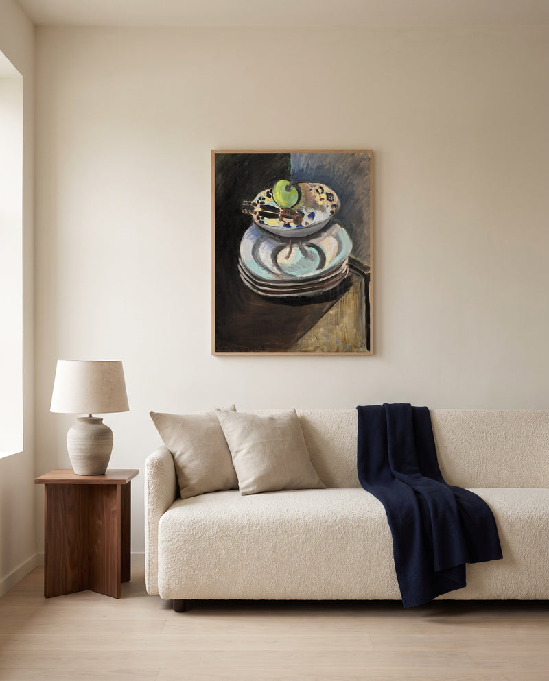 Fruit Bowl and Nutcracker by Henri Matisse framed in natural oak above a cream sofa in a warm living room