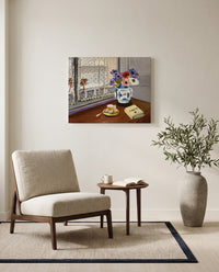 Still Life with Pascal by Henri Matisse as a stretched canvas above a linen lounge chair in a reading corner