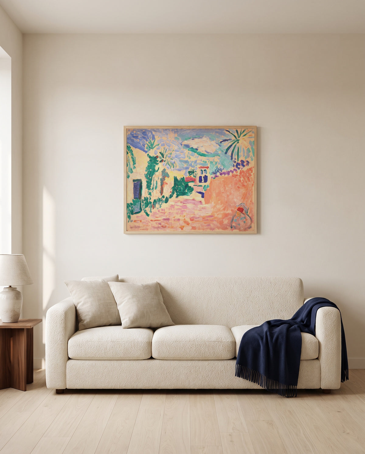 Street in Biskra by Henri Matisse framed in natural oak above a cream sofa in a warm living room