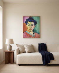 The Green Stripe by Henri Matisse framed in natural oak above a cream sofa in a warm living room