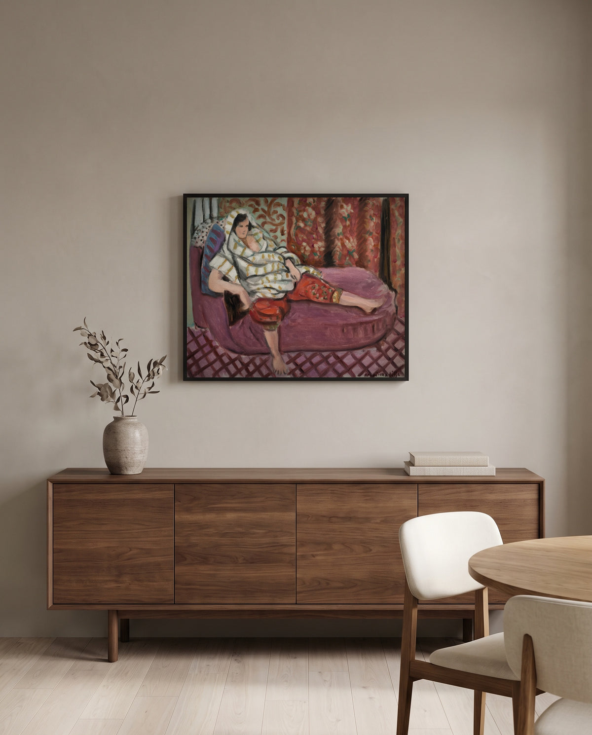 Woman on Rose Divan by Henri Matisse in a black frame above a walnut sideboard in a dining room