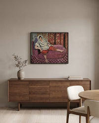 Woman on Rose Divan by Henri Matisse in a black frame above a walnut sideboard in a dining room