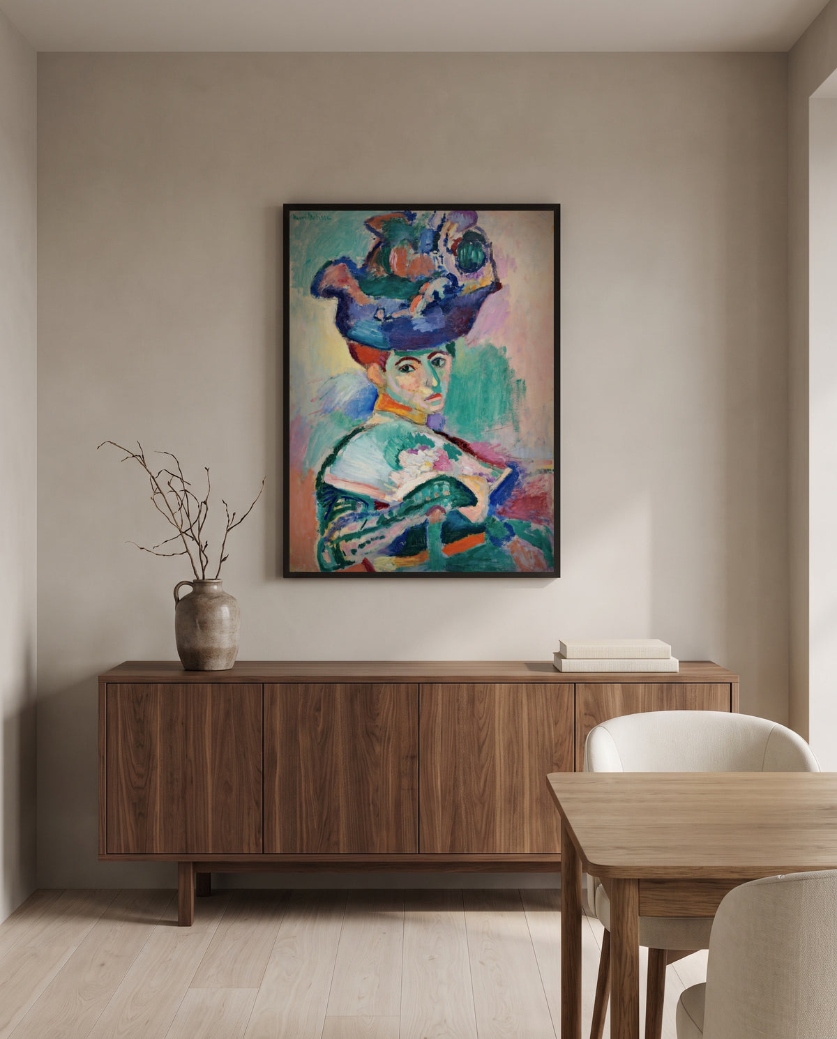 Woman with a Hat by Henri Matisse in a black frame above a walnut sideboard in a dining room