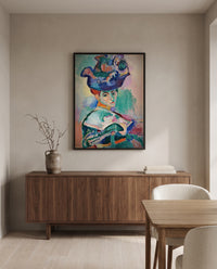 Woman with a Hat by Henri Matisse in a black frame above a walnut sideboard in a dining room