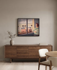 Young Woman at the Sea by Henri Matisse in a black frame above a walnut sideboard in a dining room