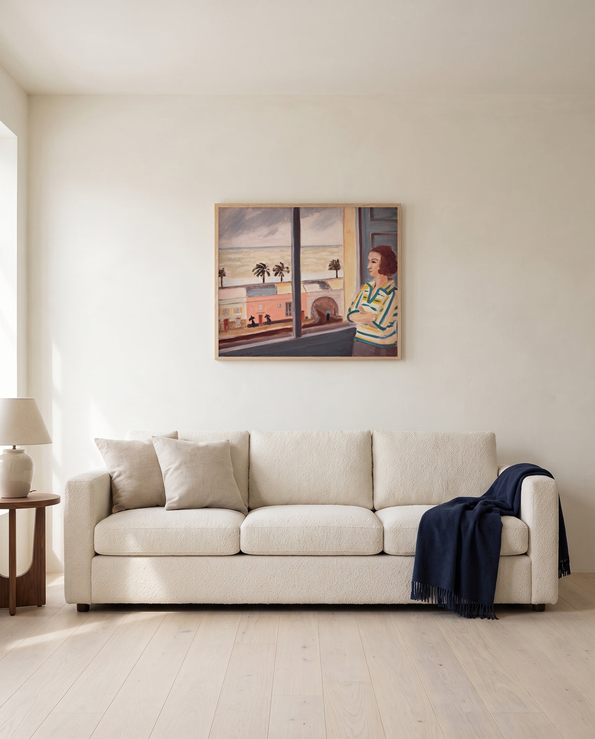 Young Woman at the Sea by Henri Matisse framed in natural oak above a cream sofa in a warm living room