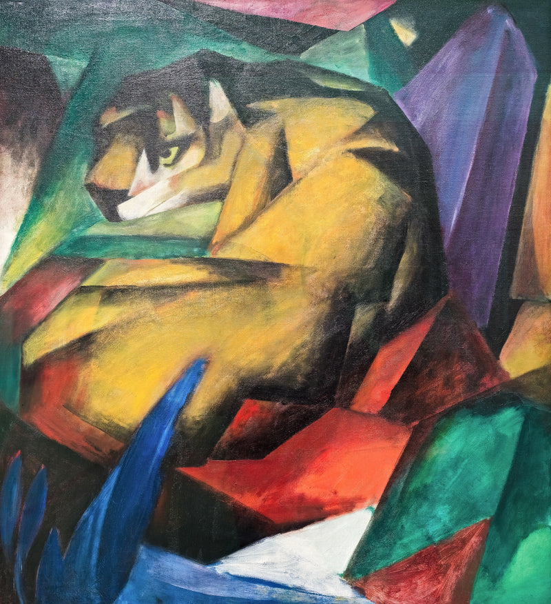 The Tiger by Franz Marc: a crouching yellow tiger built of angular planes among red, green and violet rocks