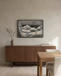 Evening Snow at Kambara by Utagawa Hiroshige in a black frame above a walnut sideboard in a dining room