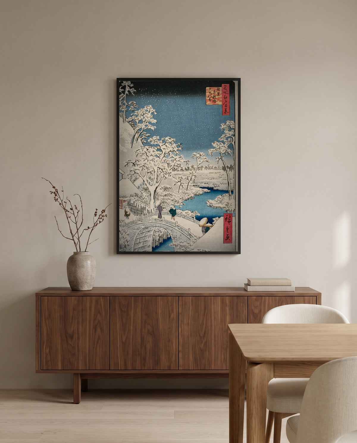 Meguro Drum Bridge by Utagawa Hiroshige in a black frame above a walnut sideboard in a dining room