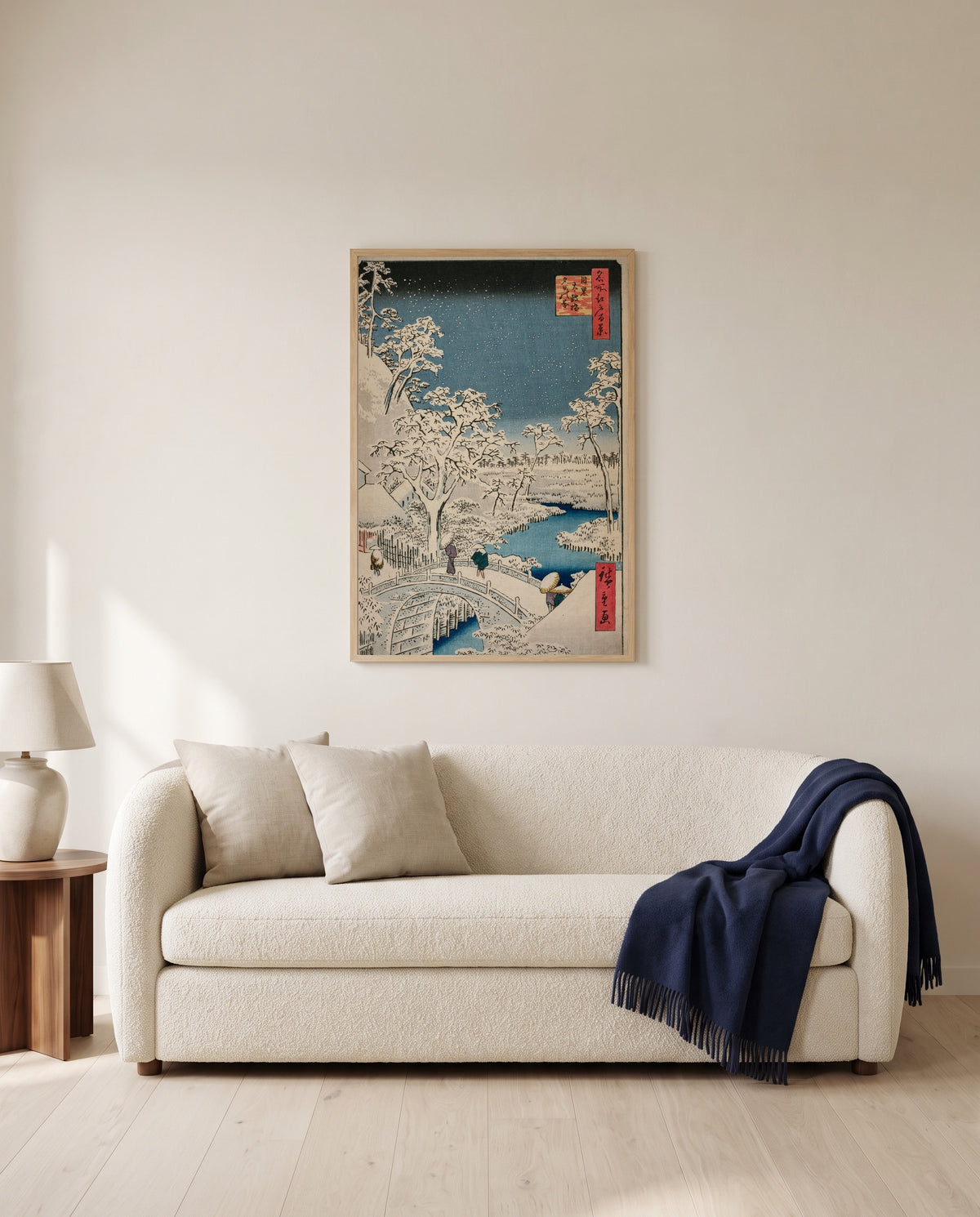 Meguro Drum Bridge by Utagawa Hiroshige framed in natural oak above a cream sofa in a warm living room