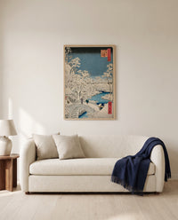 Meguro Drum Bridge by Utagawa Hiroshige framed in natural oak above a cream sofa in a warm living room