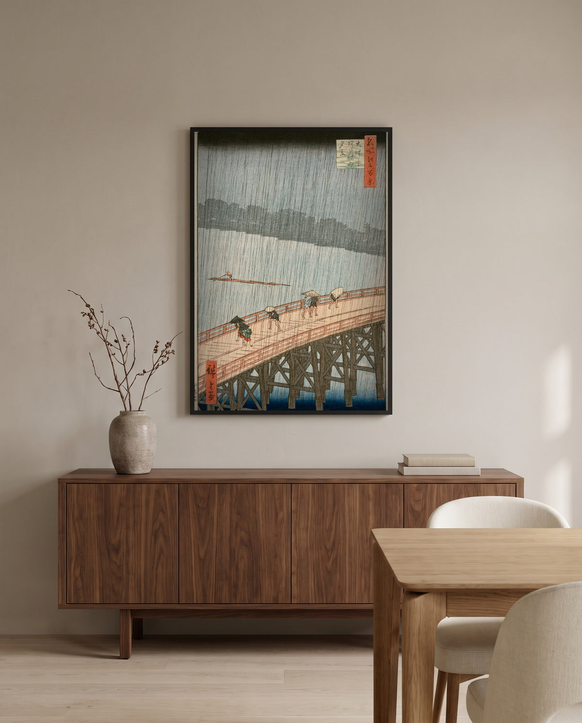 Sudden Shower at Ōhashi by Utagawa Hiroshige in a black frame above a walnut sideboard in a dining room