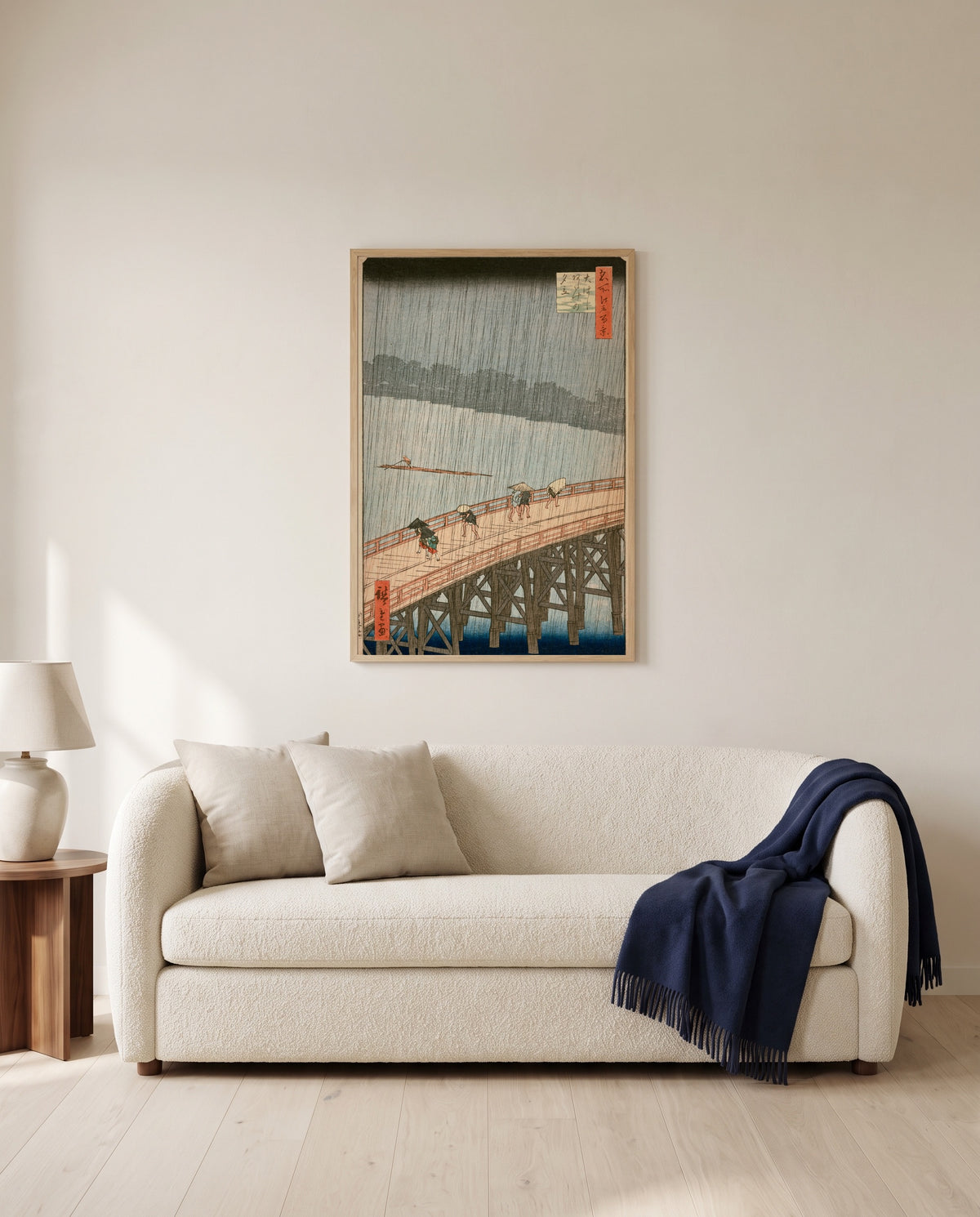 Sudden Shower at Ōhashi by Utagawa Hiroshige framed in natural oak above a cream sofa in a warm living room