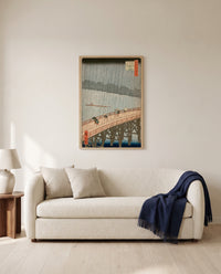 Sudden Shower at Ōhashi by Utagawa Hiroshige framed in natural oak above a cream sofa in a warm living room