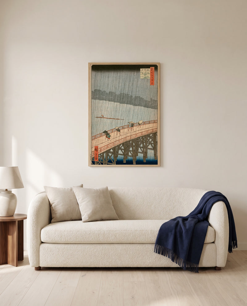 Sudden Shower at Ōhashi by Utagawa Hiroshige framed in natural oak above a cream sofa in a warm living room