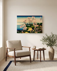 Goten Hill at Shinagawa by Katsushika Hokusai as a stretched canvas above a linen lounge chair in a reading corner