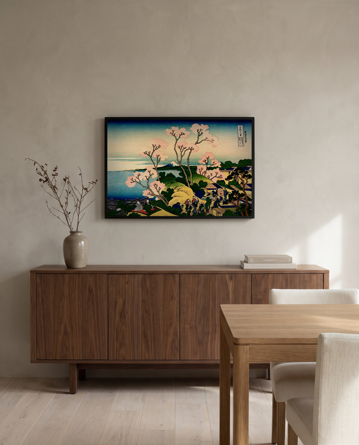 Goten Hill at Shinagawa by Katsushika Hokusai in a black frame above a walnut sideboard in a dining room