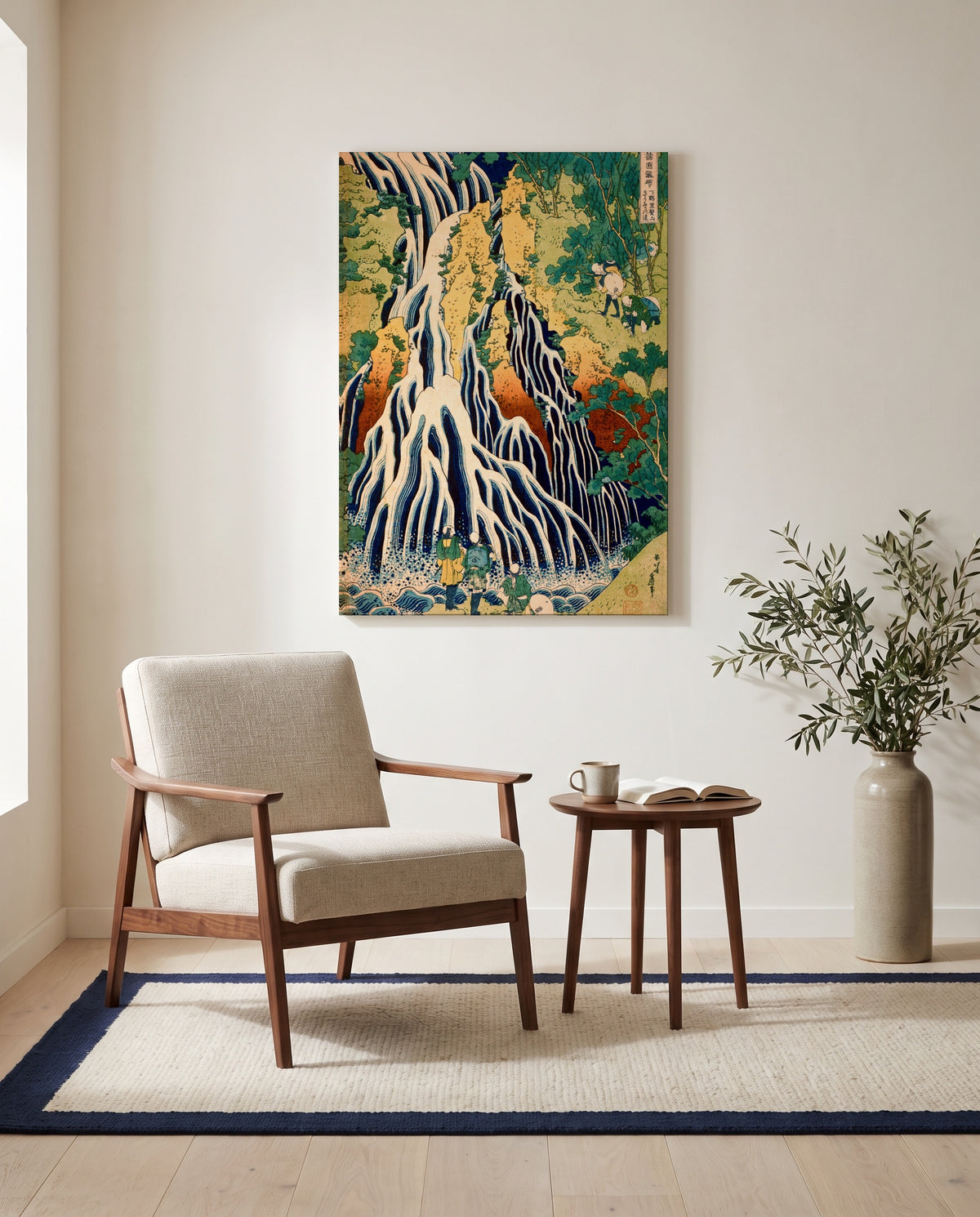 Kirifuri Waterfall by Katsushika Hokusai as a stretched canvas above a linen lounge chair in a reading corner