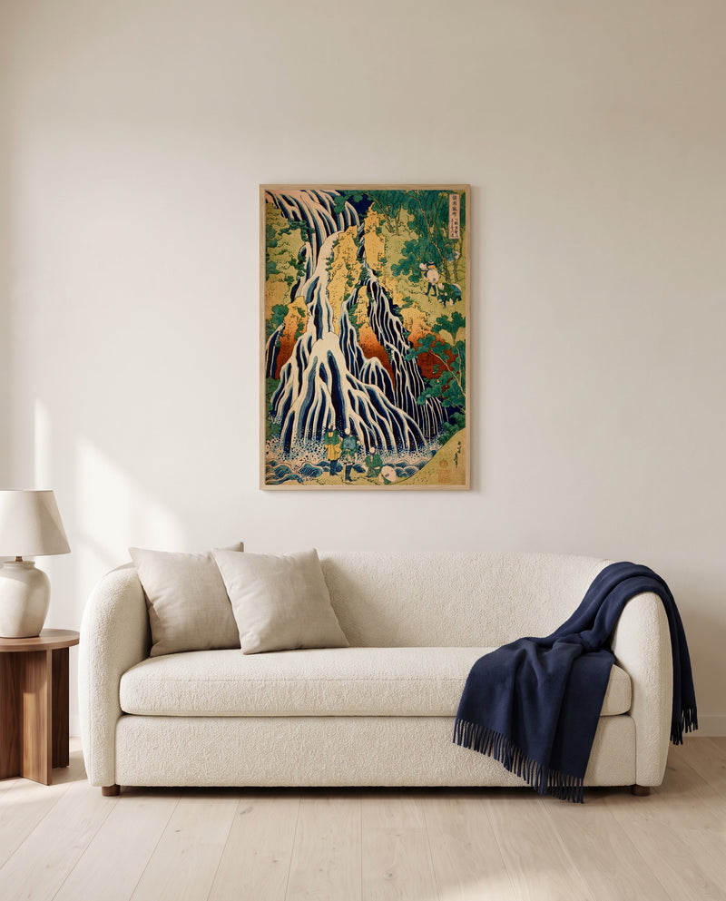 Kirifuri Waterfall by Katsushika Hokusai framed in natural oak above a cream sofa in a warm living room