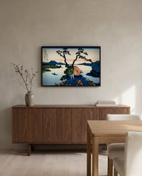 Lake Suwa in Shinano Province by Katsushika Hokusai in a black frame above a walnut sideboard in a dining room
