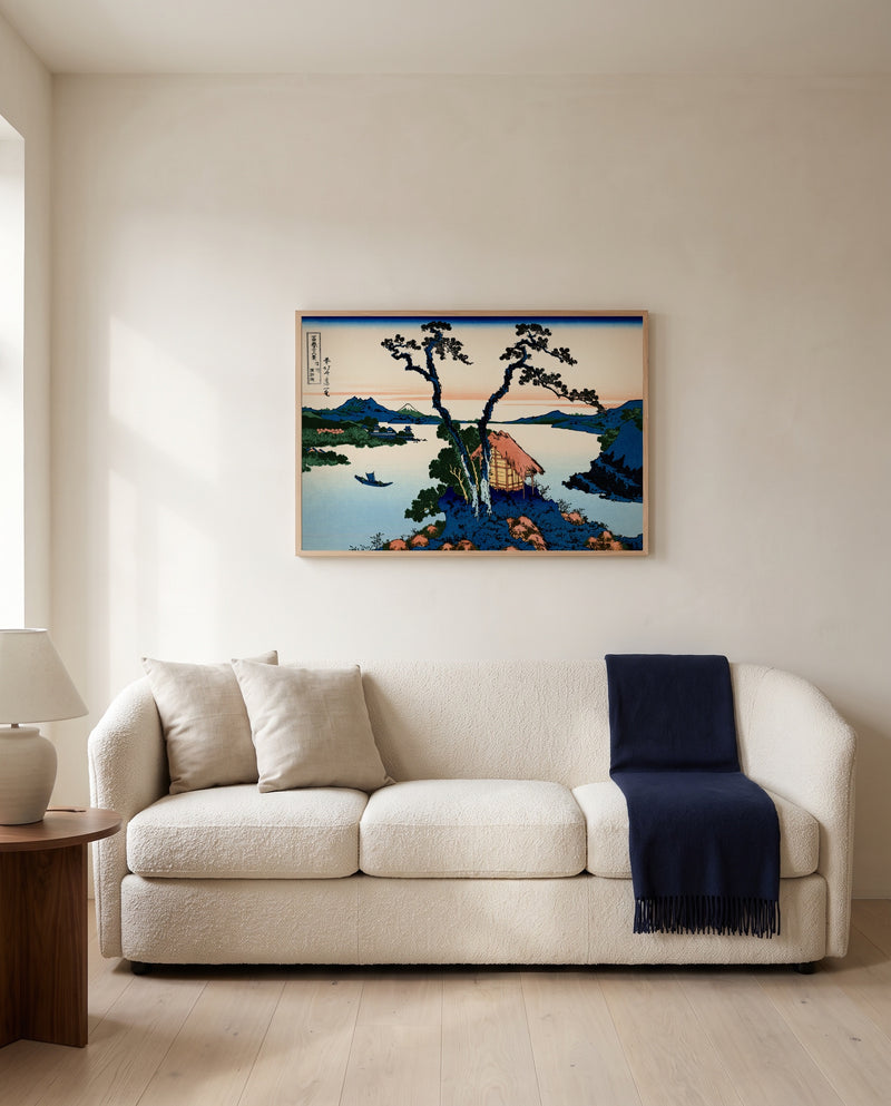 Lake Suwa in Shinano Province by Katsushika Hokusai framed in natural oak above a cream sofa in a warm living room