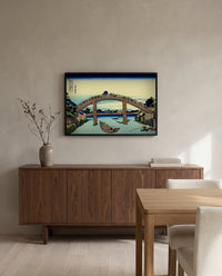 Under Mannen Bridge at Fukagawa by Katsushika Hokusai in a black frame above a walnut sideboard in a dining room