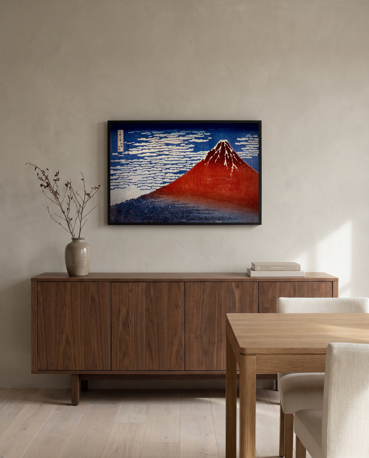 Red Fuji by Katsushika Hokusai in a black frame above a walnut sideboard in a dining room