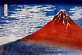 Fine Wind, Clear Morning by Hokusai: Mount Fuji in deep red under a blue sky of small white clouds, dark forest below
